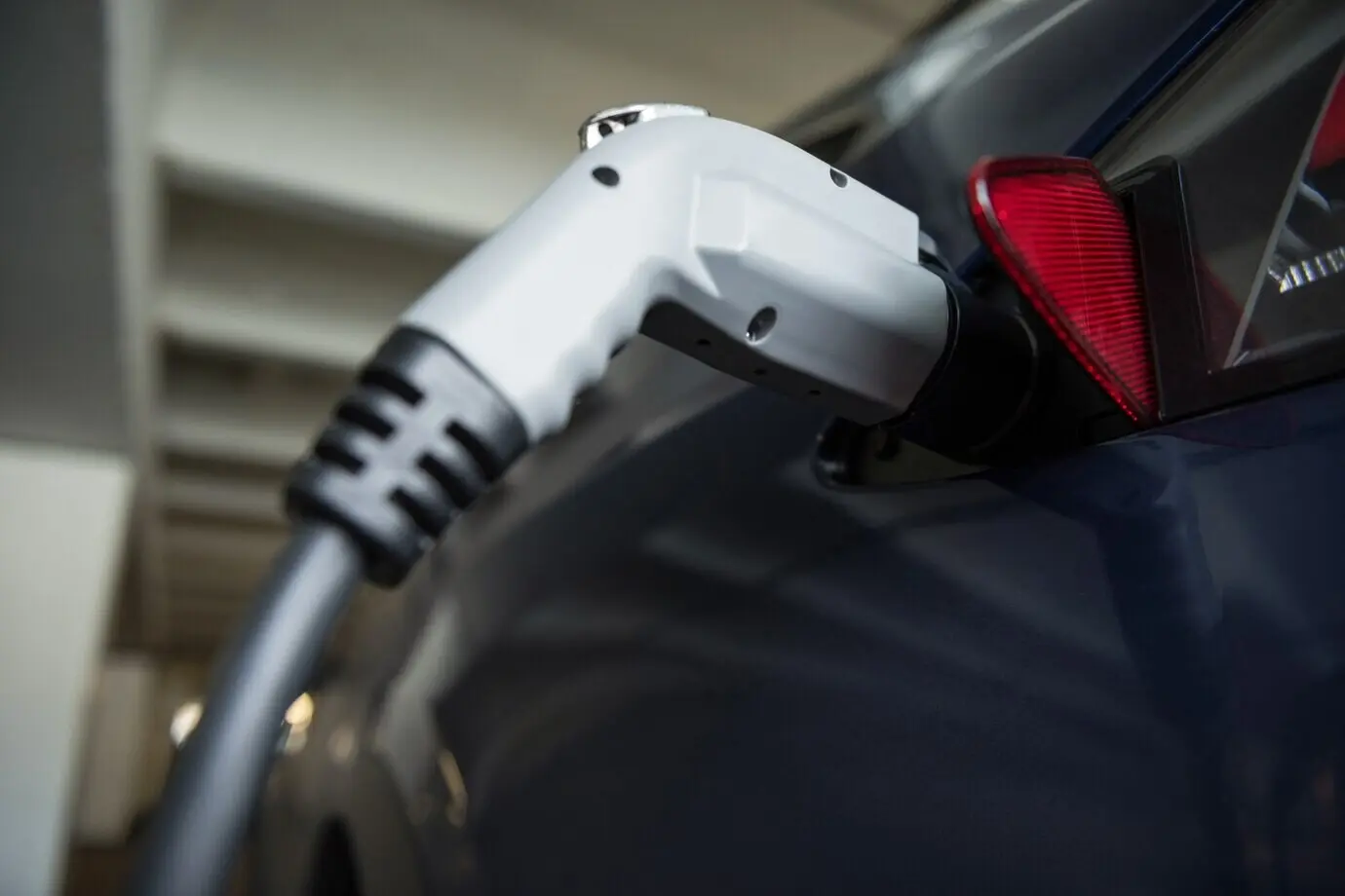 Close-up view of a car being charged with an electric car charger.