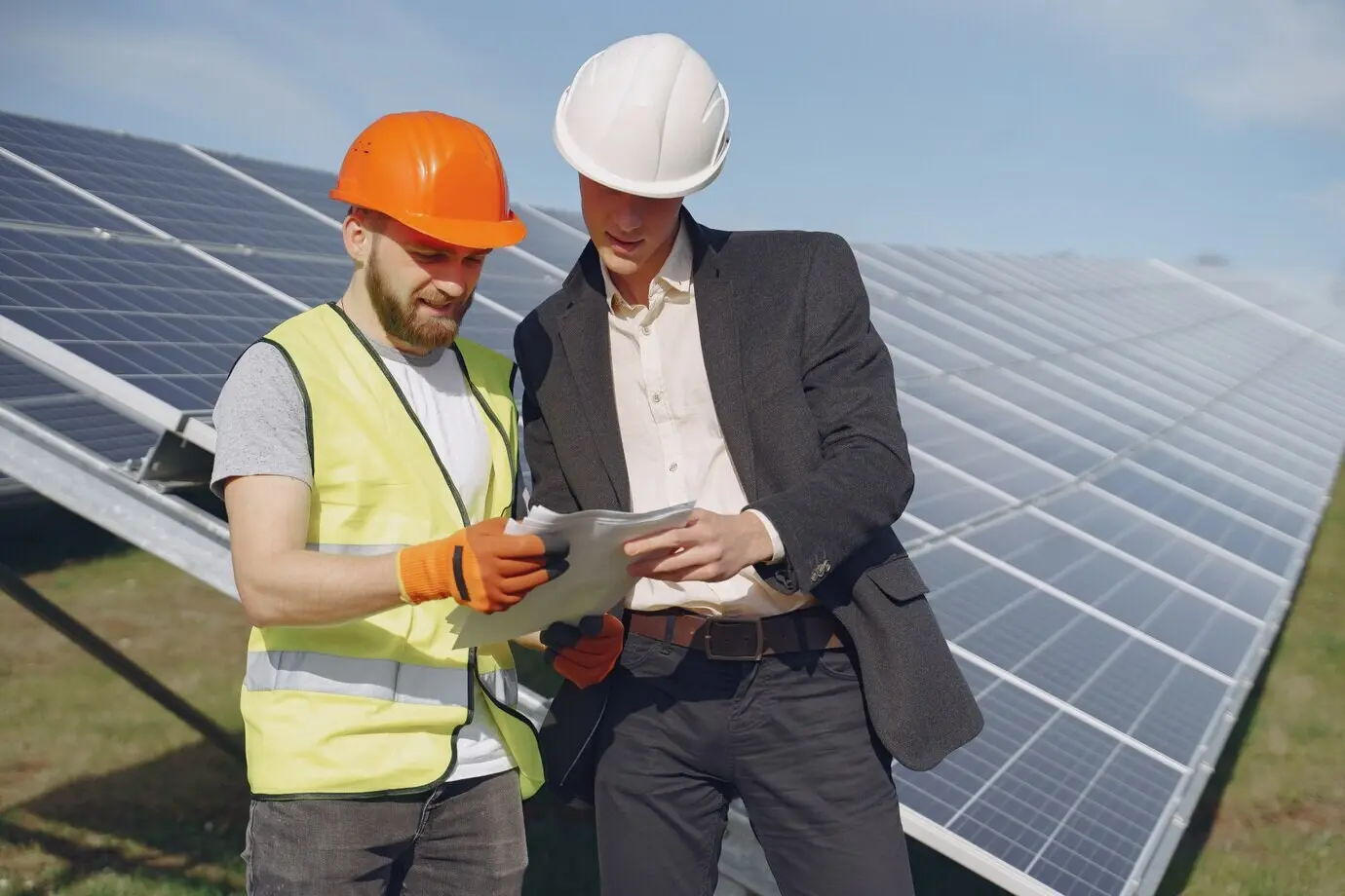 A foreman and a businessman at a solar energy station.
